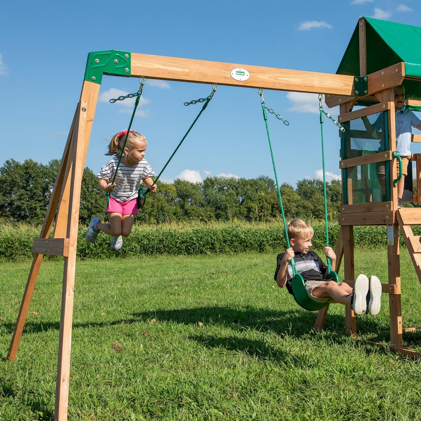 Backyard Discovery Buckley Hill Cedar Wood Swing Set with Wave Slide, Play Deck, Rock Wall Ladder, Belt Swings, Chalkboard, Canopy Roof, Outdoor Playset